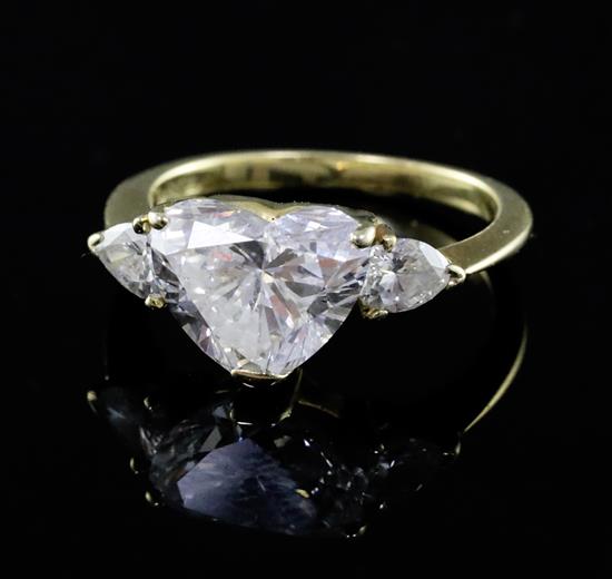 A 1980s Kutchinsky 18ct gold heart shaped diamond set dress ring with pear cut diamond set shoulders, size J.